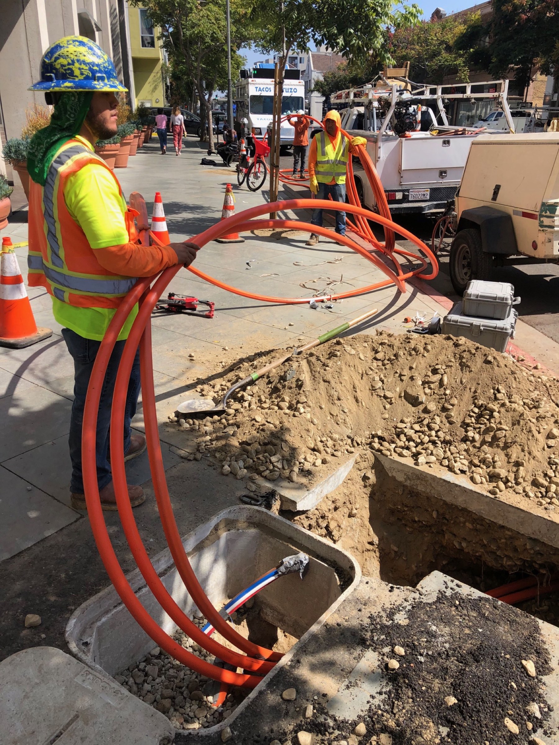 Fiber optic cable installation by utility construction crew