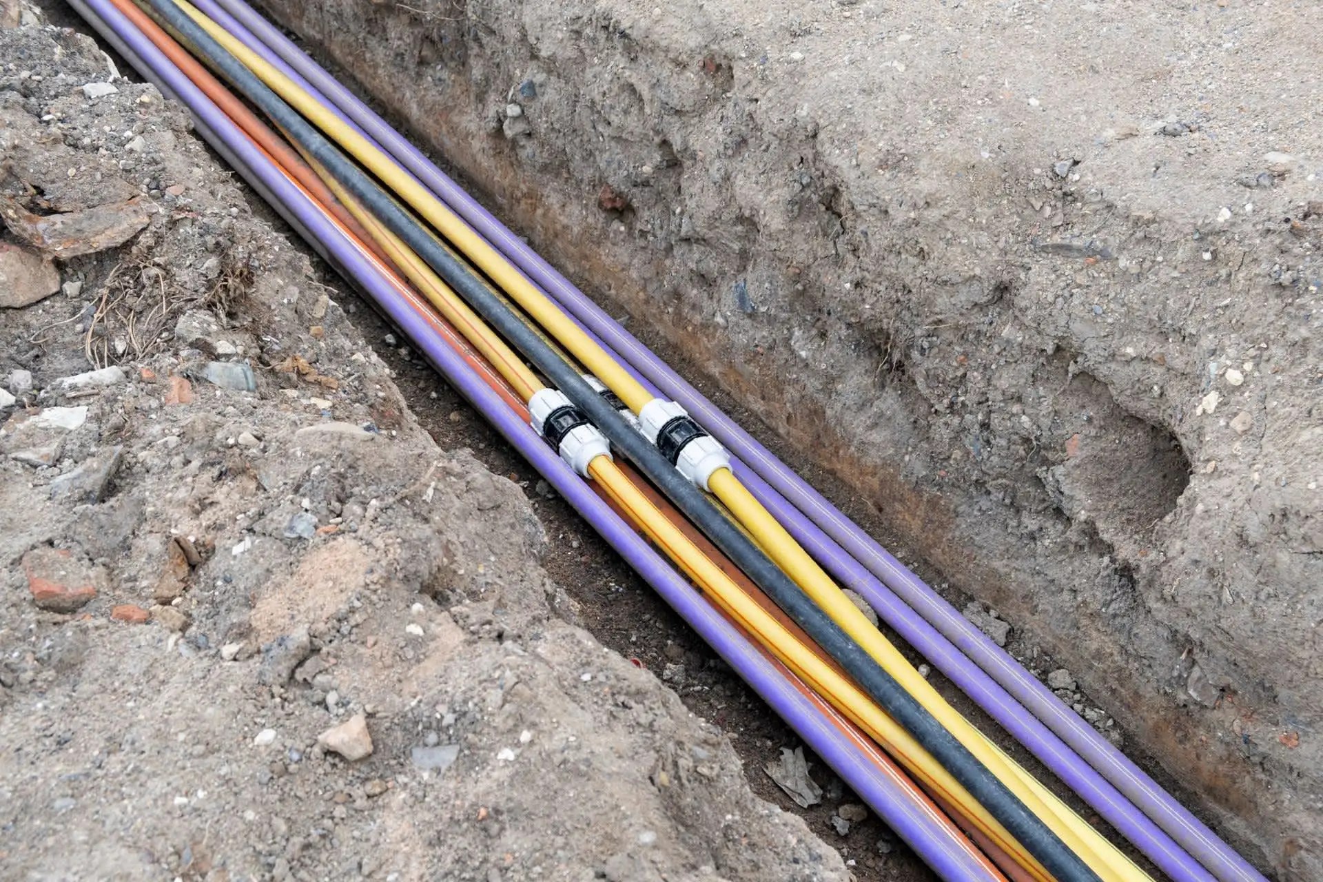 Underground utility conduits installed in a trench