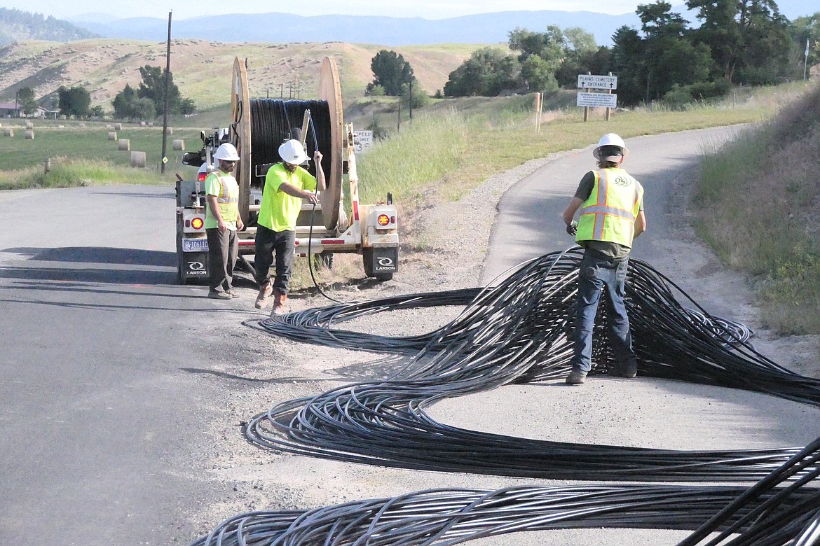 Fiber optic cable installation by utility crew